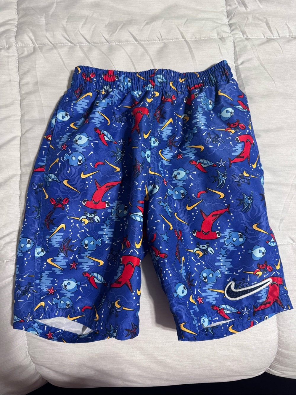 Nike Blue Kids Swim Shorts with Red and Yellow Accents